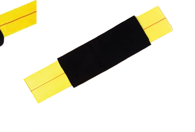 A protective sleeve fitted over yellow strap webbing, shielding it where it crosses a load edge