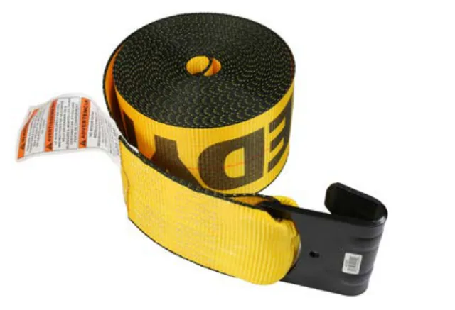 A Kinedyne winch strap: yellow webbing with a flat hook on the loose end, the other end wound onto a trailer winch